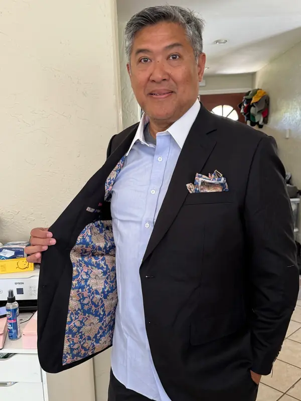 Raymik Custom Tailor fitting a client for a custom dress shirt
