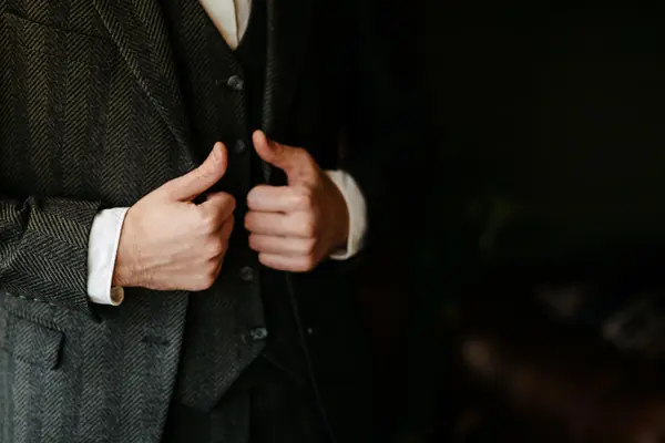 Close-up of a custom tweed waistcoat and tailored cuffs